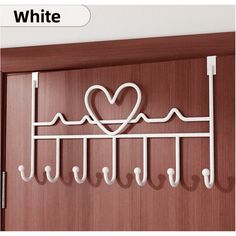 a white coat rack with hearts on it