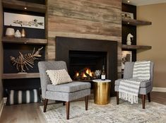 a living room with two chairs and a fire place