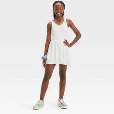 Why we're ALL IN: Solid-color sleeveless active dress with built-in shorts and a pleated skirt. Made from recycled polyester fabric with added spandex for flexible wear. Boasts moisture-wicking and quick-drying construction for comfort during any activity. The hidden pocket, built-in shorts, V-neckline and keyhole cut-out back complete the sporty design. All in Motion™: Inspiring the potential in every body. Summer School Mini Dress, Stretch Skirted Tennis Dress For Spring, Casual Stretch Mini Tennis Dress, Casual Stretch Mini-length Tennis Dress, Summer Skirted Stretch Tennis Dress, Casual Mini Dress For School In Spring, Casual Summer School Dresses, Casual Solid Dresses For School, Sleeveless Summer School Dress