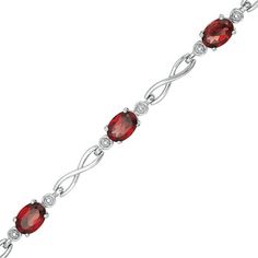 Wrap her wrist in chic style with this remarkable infinity link bracelet. Crafted in sterling silver, this winsome choice features 7.0 x 5.0mm oval-shaped lab-created regal red garnets flanked by round beaded accents. Polished infinity symbol-shaped links complete this alternating design. Buffed to a brilliant luster, this 7.5-inch bracelet secures with a lobster claw clasp. Infinity Symbol Tattoo, Infinity Tattoos, Celtic Tattoos, Dragon Tattoo Designs, Skull Tattoo Design, Handmade Wire Jewelry, Infinity Symbol, Garnet Stone, Red Stone