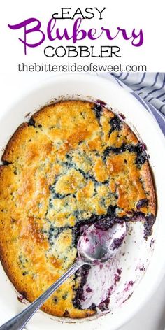 a blueberry cobbler in a white bowl with a serving spoon on the side