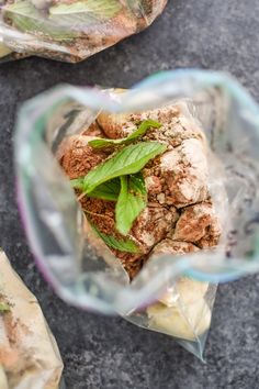 some food is in a plastic bag on the ground next to another bag with something inside it