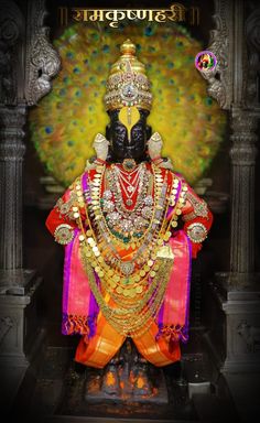 an idol is displayed in front of a colorful background