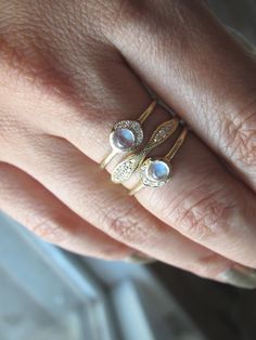 Within women lives the power to create, nourish and renew. Let's take the time to reflect on and celebrate this unique power. 4mm rainbow moonstone. White round brilliant diamonds 0.03cts. #moonstonering #moonstonejewelry #ringstack #goldringstack #rings #goldjewelry 14k Gold Moonstone Promise Ring With Rose Cut Diamonds, Diamond White Moonstone Ring With Rose Cut Diamonds, Anniversary Yellow Gold Moonstone Ring With Diamond Accents, Celestial Stackable Diamond Jewelry, Fine Jewelry Moonstone Ring With Single Cut Diamonds, Moonstone Jewelry With Rose Cut Diamonds, Celestial Moonstone Jewelry With Rose Cut Diamonds, Celestial Diamond White Jewelry With Rose Cut Diamonds, Round Moonstone Jewelry With Rose Cut Diamonds