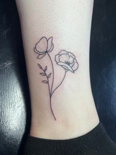 a small flower tattoo on the ankle