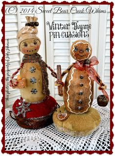 two snowmen made out of gingerbreads sitting on top of a doily