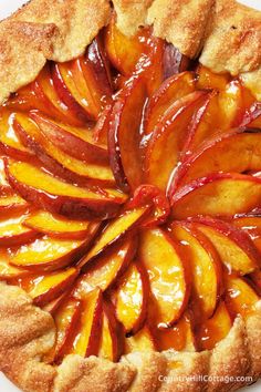 a peach pie with slices cut out on the top and toppings in the middle