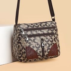 a brown and white purse sitting on top of a table