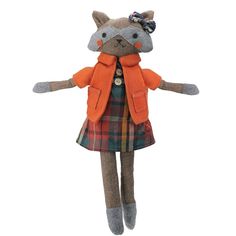 a stuffed animal wearing an orange coat and plaid dress is standing on its hind legs