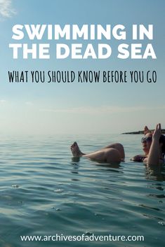 two people swimming in the dead sea with text overlay that reads, swimming in the dead sea what you should know before you go