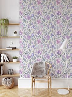 a chair in front of a wallpaper with purple flowers and leaves on the background