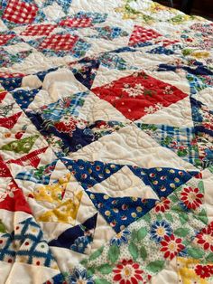 a colorful quilt is laying on the bed