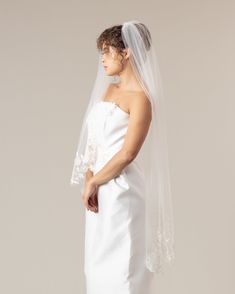 Intricately embroidered floral edge on an asymmetrical veil. Shown in Photos: Off-White 50"L Made with tulle, embroidered with organza, cotton and silk thread. Made to order. Allow 5-7 weeks for delivery. Visit our Buying Guide for information on shipping, returns, local currency and more. Tulle Wedding Veil With Lace Trim, Fitted Sheer White Veil, Wedding Veil With Lace Trim In Tulle, Fitted Tulle Veil For Ceremony, Organza Veil For Ceremony, White Fitted Veil For Mother Of The Bride, Wedding Veil With Lace Trim, Elbow Length Veil, Silk Thread