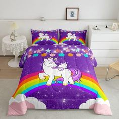 a bed with a purple unicorn and rainbows on it