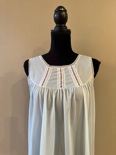 A lightweight sleeveless nightgown in light blue.  Lace trim on the bodice as well as the neckline and armholes.  The fabric is on the sheer side.  In good vintage condition with no rips or stains.  The bust measures 17.5 inches from armpit to armpit laying flat.  34 inches from shoulder to hem.  Tag reads Heiress size Medium. Sleeveless Sleepwear For Spring Vacation, Flowy Lace Trim Summer Nightgown, Summer Lace Trim Nightgown For Loungewear, Summer Nightgown With Lace Trim For Loungewear, Summer Beach Nightgown With Lace Trim, Flowy Sleeveless Dress For Loungewear, Blue Sleeveless Sleep Tank Top, Flowy Sleeveless Lounge Dress, Sheer Spring Nightgown For Bedtime