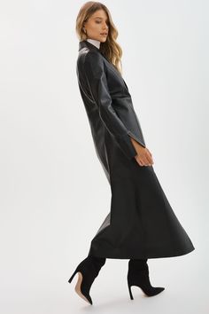 Step out in style with the Evanna Leather Maxi Coat. This single-breasted coat features lateral side slits, clean lines and minimalist details. Whether you're heading to a formal event or simply want to elevate your everyday look, the Evanna Leather Maxi Coat is the perfect choice. Sleek Notch Lapel Blazer Dress, Elegant Single-breasted Long Leather Jacket, Elegant Single Breasted Long Leather Jacket, Single-breasted Long Leather Jacket For Work, Single-breasted Leather Long Coat For Work, Elegant Long Single-breasted Leather Jacket, Elegant Long Single Breasted Leather Jacket, Single Breasted Leather Long Coat For Work, Chic Long Coat Leather Jacket For Formal Occasions