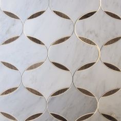 a white marble tile with brown circles and lines on the bottom, in an elegant pattern