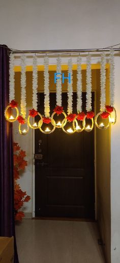 a doorway with some lights hanging from it's ceiling and decorations on the door