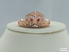 this is an image of a ring with diamonds and garnets on the band