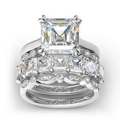 an engagement ring set with a princess cut diamond in the center and side stones on each band