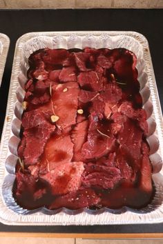 the meat in the baking dish is ready to be cooked and put into the oven