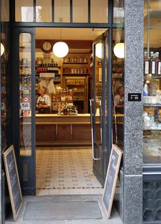 the entrance to a restaurant with signs in front of it