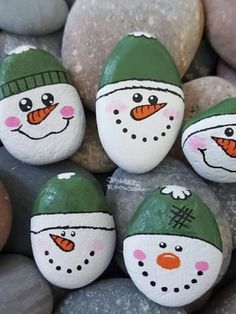 four painted rocks with snowmen on them