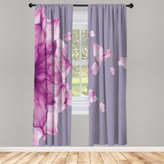 purple curtains with pink flowers on them in front of a white wall and wooden floor