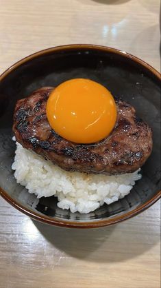 an egg is on top of rice in a bowl