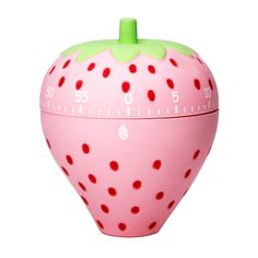 a pink and green strawberry shaped clock with red dots on it's face, sitting in front of a white background