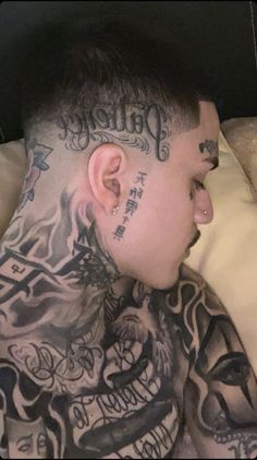 a man with tattoos on his neck and chest