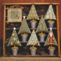 a wooden shelf filled with potted plants and christmas trees on top of each other