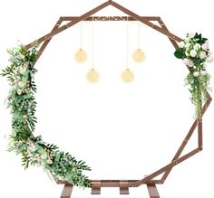 a wooden frame with flowers and greenery hanging from the side on a white background