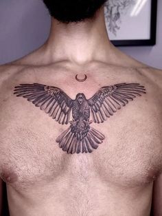 a man's chest with a bird tattoo on the upper part of his chest