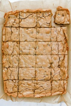 an image of baked dessert on parchment paper with crackers and icing around the edges