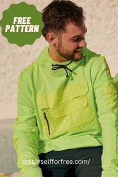 a man sitting down wearing a green shirt