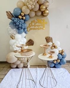 two tables topped with balloons and cake stands