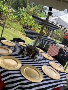 the table is set with plates and place settings