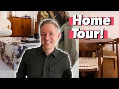 a man sitting in front of a table next to a couch and chair with the words home tour written on it