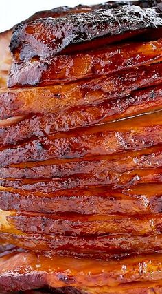 a stack of bacon sitting on top of a wooden cutting board