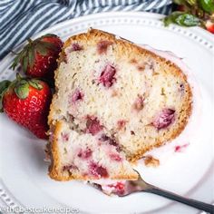 a close up of a piece of cake on a plate with strawberries