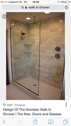 a walk in shower sitting next to a white tiled wall and floor with two lights on each side