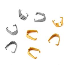 five pairs of gold and silver ear clips on a white background with clippings