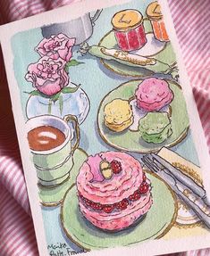 there is a card with some food on it and a cup of coffee next to it