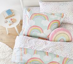 a bed with rainbows and polka dots on it