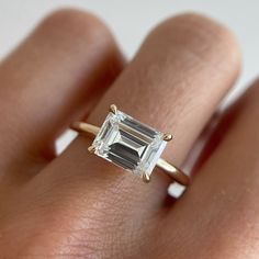 The Posey East/West Engagement Ring sounds dainty; however, she is anything but. This emerald cut ring looks amazing in a wedding stack—our latest Black Diamond Collection features several rings that complement the shape of this stackable engagement ring. 2ct engagement ring shown in pictures. 2ct Engagement Ring, Creative Engagement Rings, Stackable Engagement Ring, Emerald Cut Rings