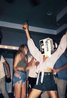 a group of people dancing and drinking at a party