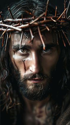 the face of jesus with crown of thorns on his head and nails all around him