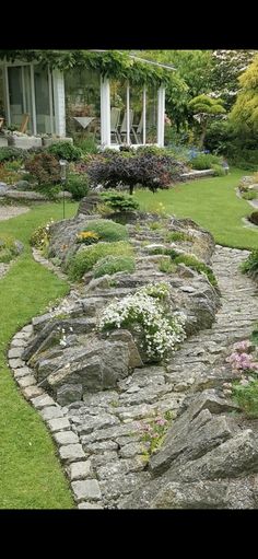 a stone path in the middle of a garden