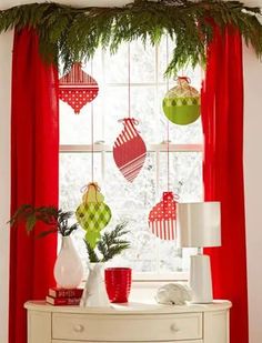 christmas decorations are hanging on the window sill